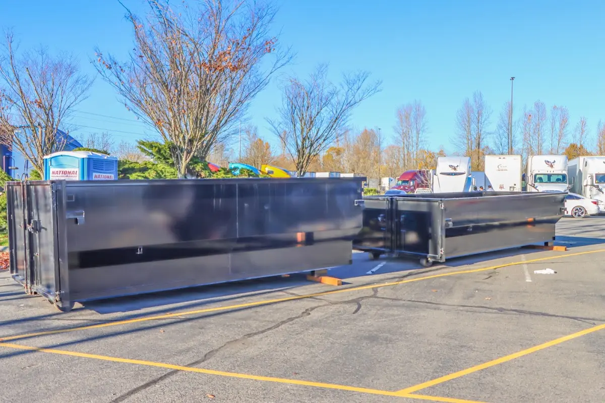 Professional dumpster rental service with roll-off container on residential driveway in Chestertown